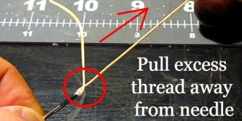 Pull excess thread away from needle